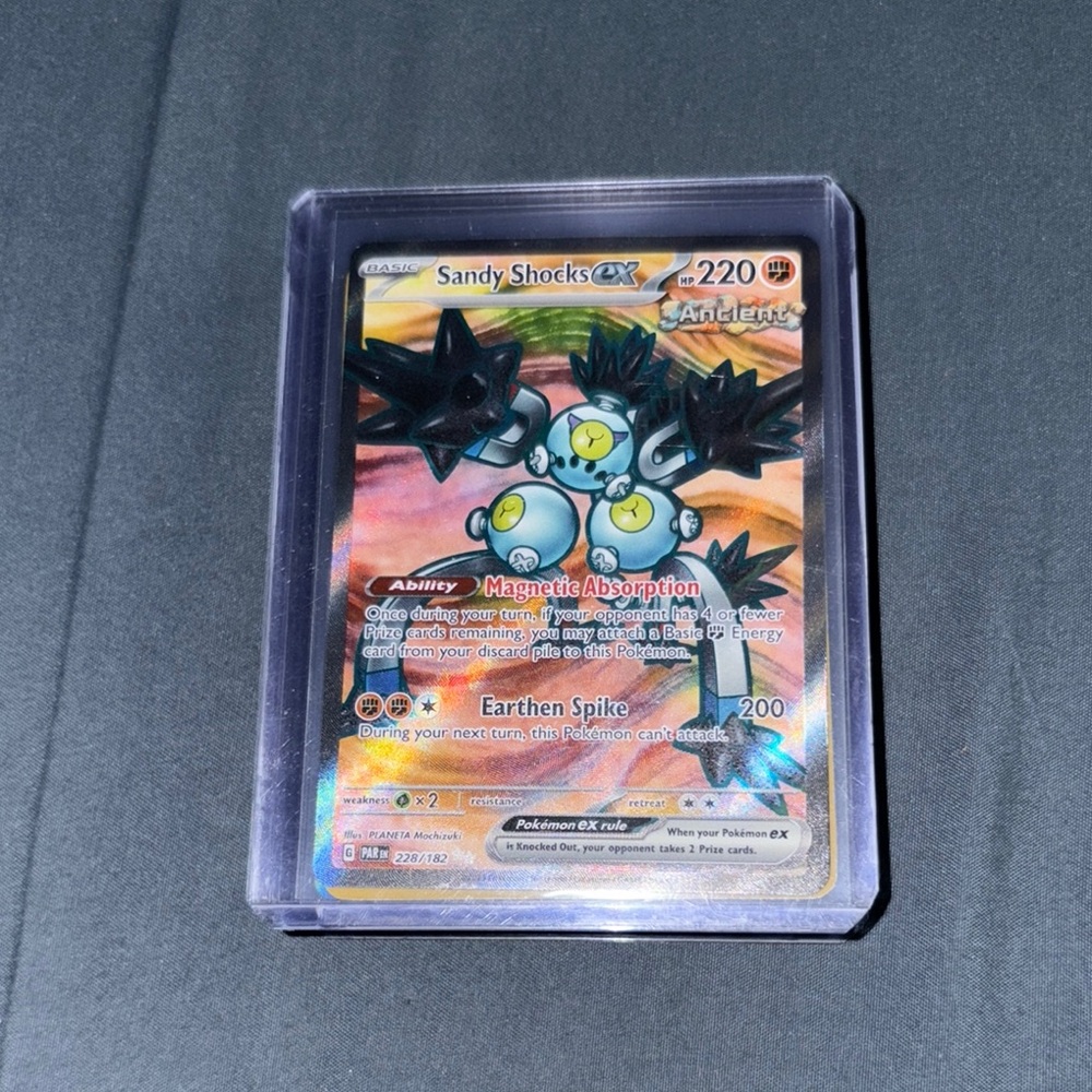 Pokemon Sandy Shocks GX Card with Black and Yellow Accents